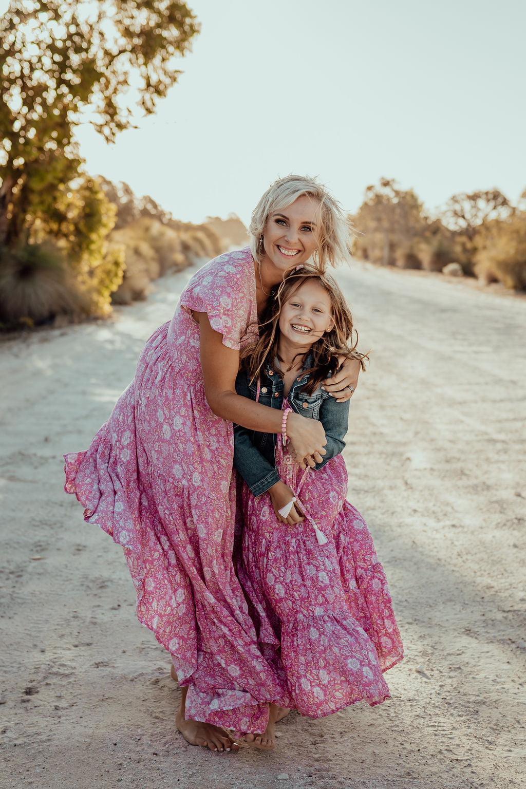 mother and daughter in matching pink loose-fitting boho dress