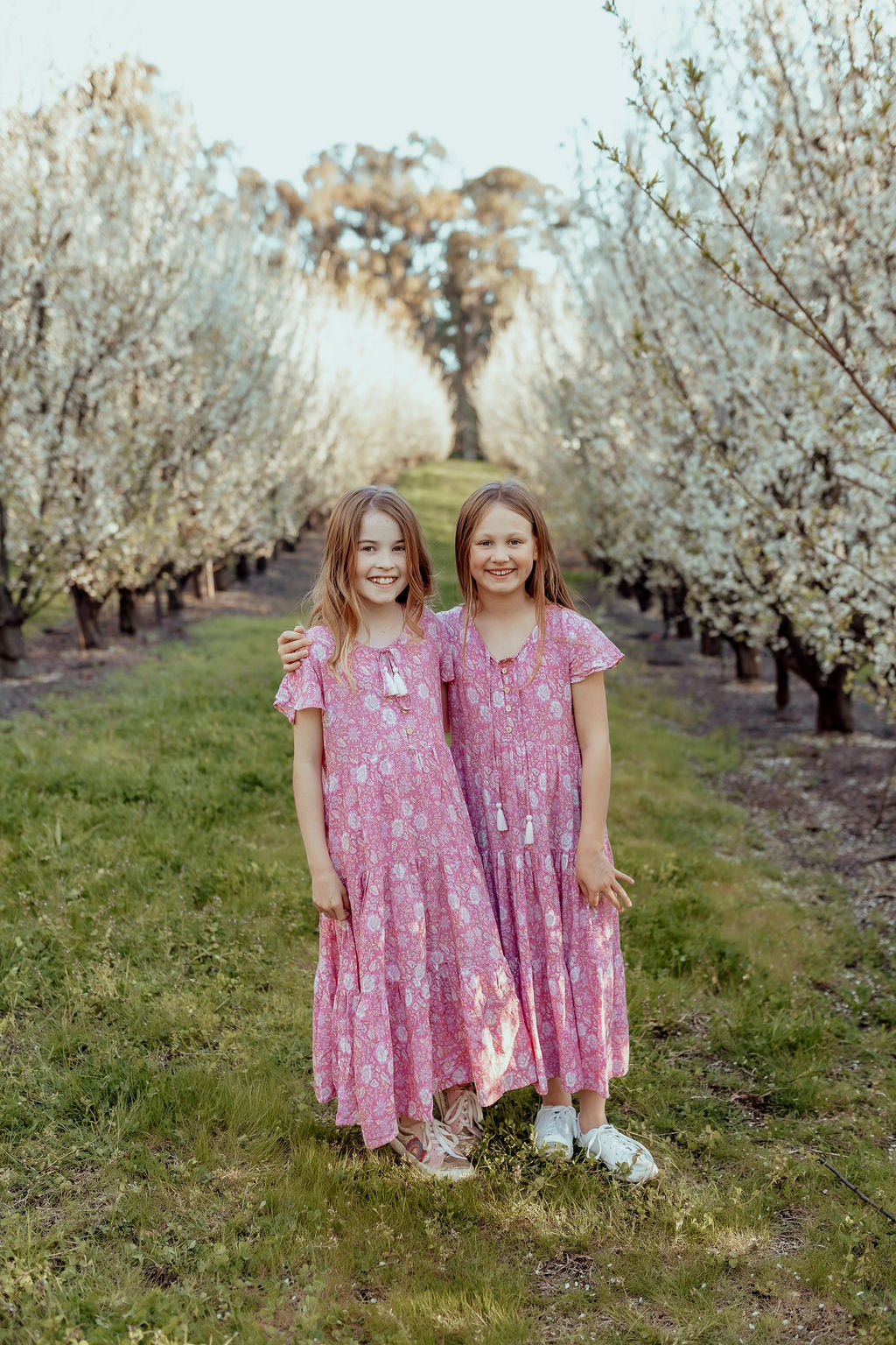 models wearing Sandi midi pink loose-fitting boho dress for little girls