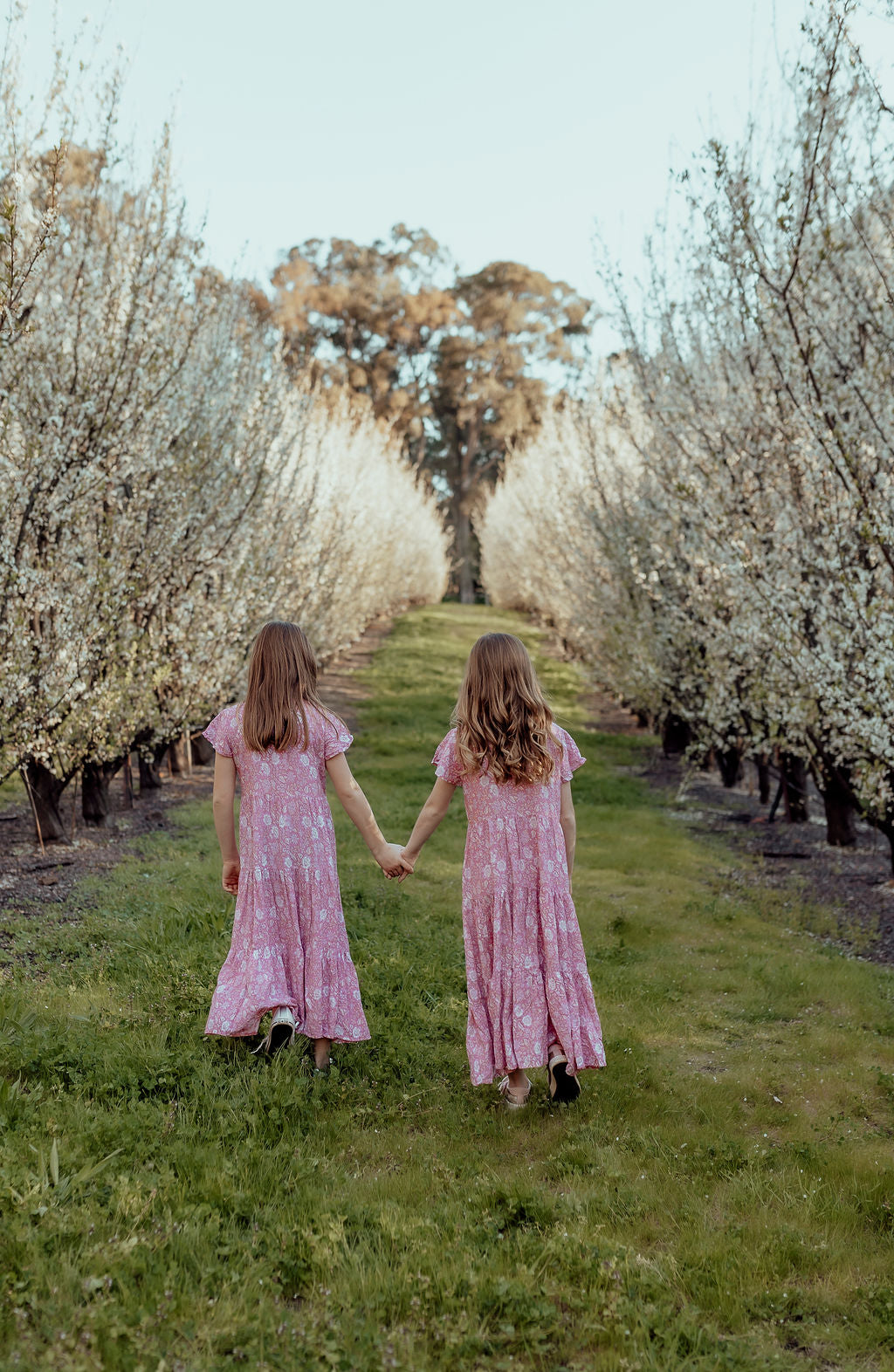 models wearing Sandi midi pink loose-fitting boho dress for little girls