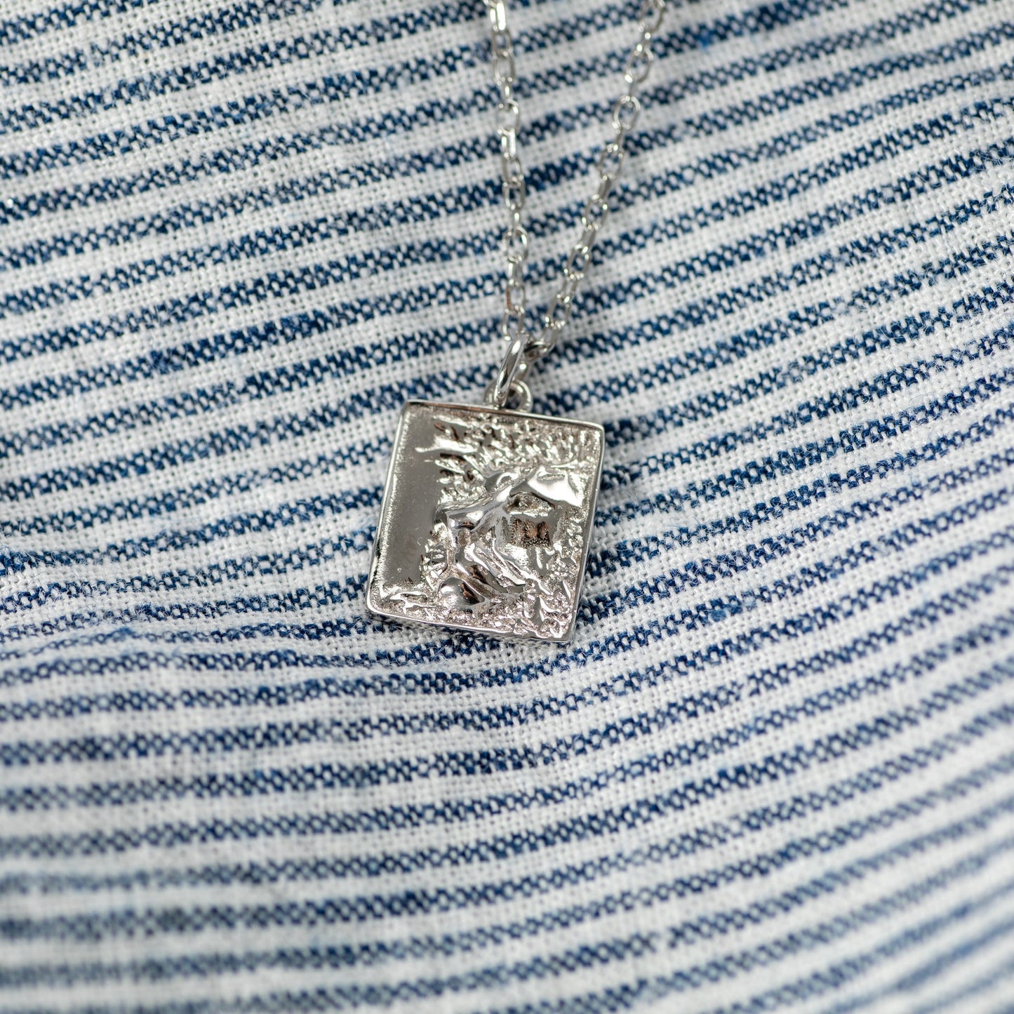 silver heart of lion necklace with square pendant