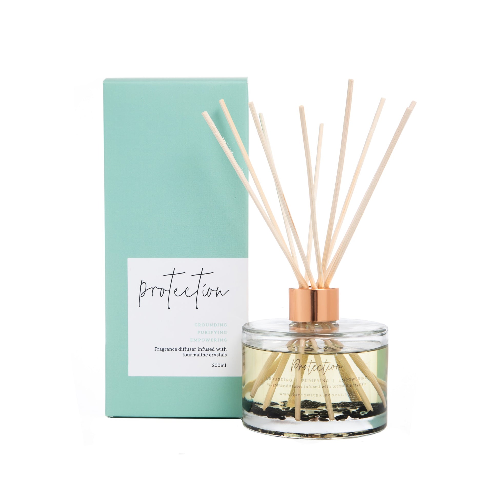 protection wooden reed diffuser in glass with oil and tourmaline beside pastel green packaging