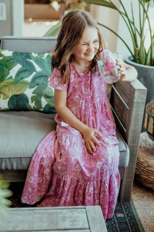 little girl in pink loose-fitting boho dress