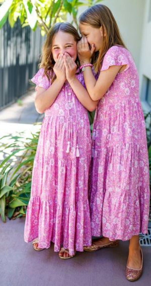 Two little girls in pink loose-fitting boho dress