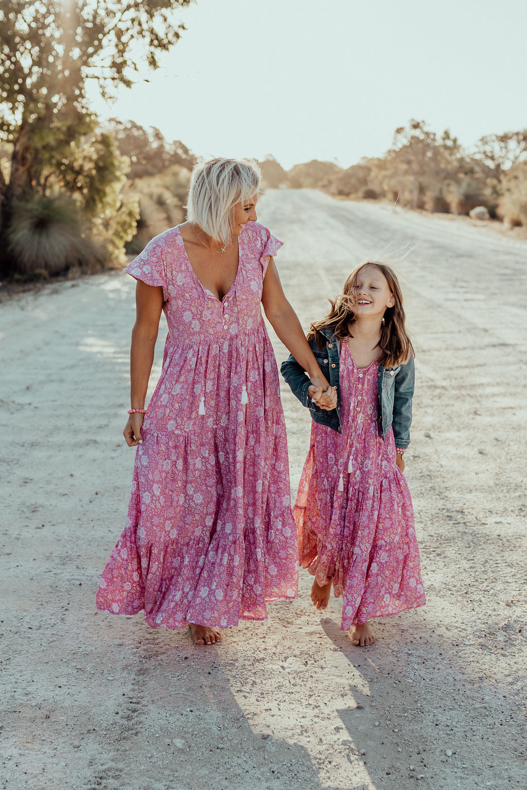 Mother and daughter in matching pink loose-fitting boho dress