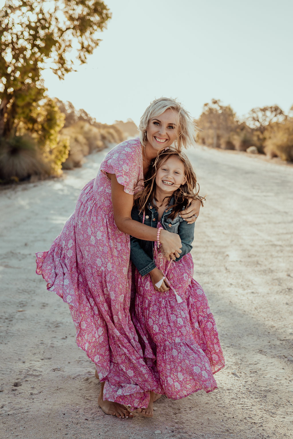 mother and daughter in matching pink loose-fitting boho dress 