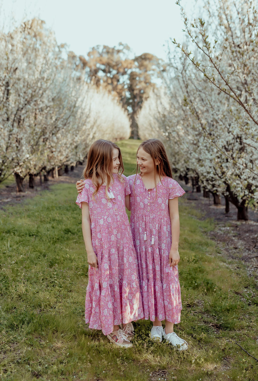 models wearing Sandi midi pink loose-fitting boho dress for little girls