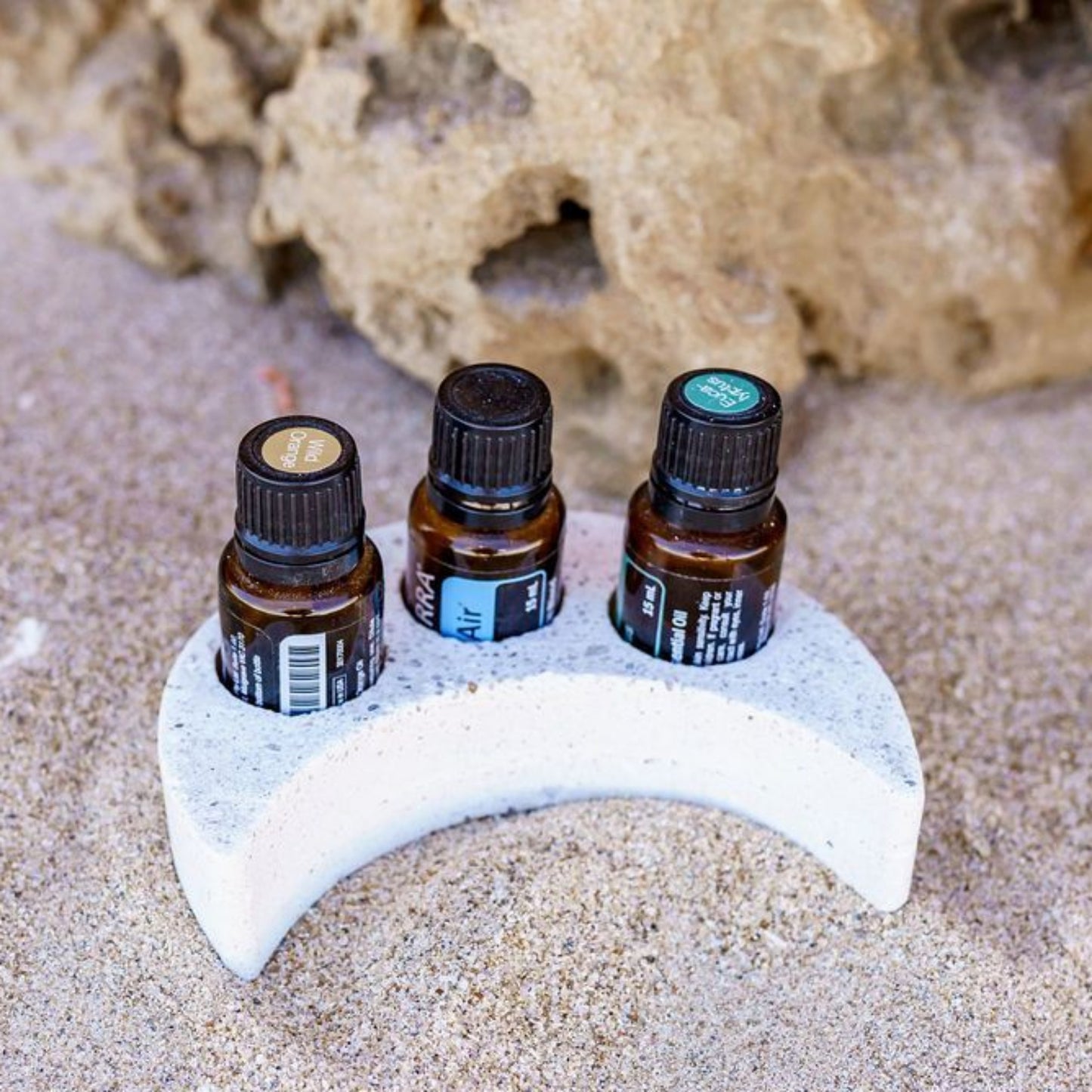 Crescent moon essential oil tray and three essential oil bottles