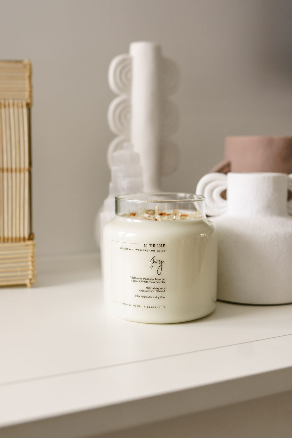 Candle Crystal Homewares Joy Citrine. Scent is Elderfloewr, Magnolia, Jasmine, Coconut, White musk, Vanilla with table decors