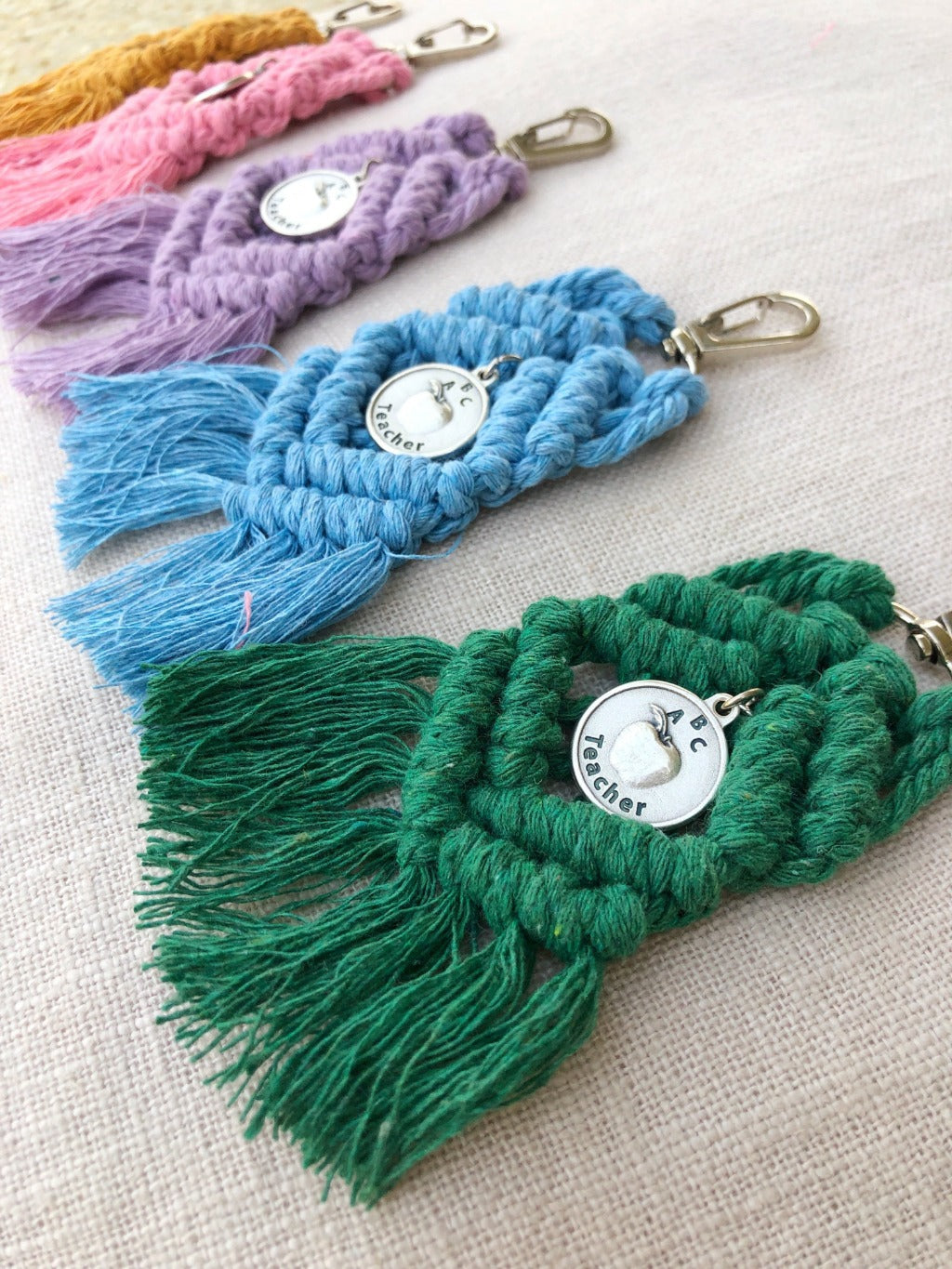 boho macrame keychains in mustard, pink, purple, blue, and green