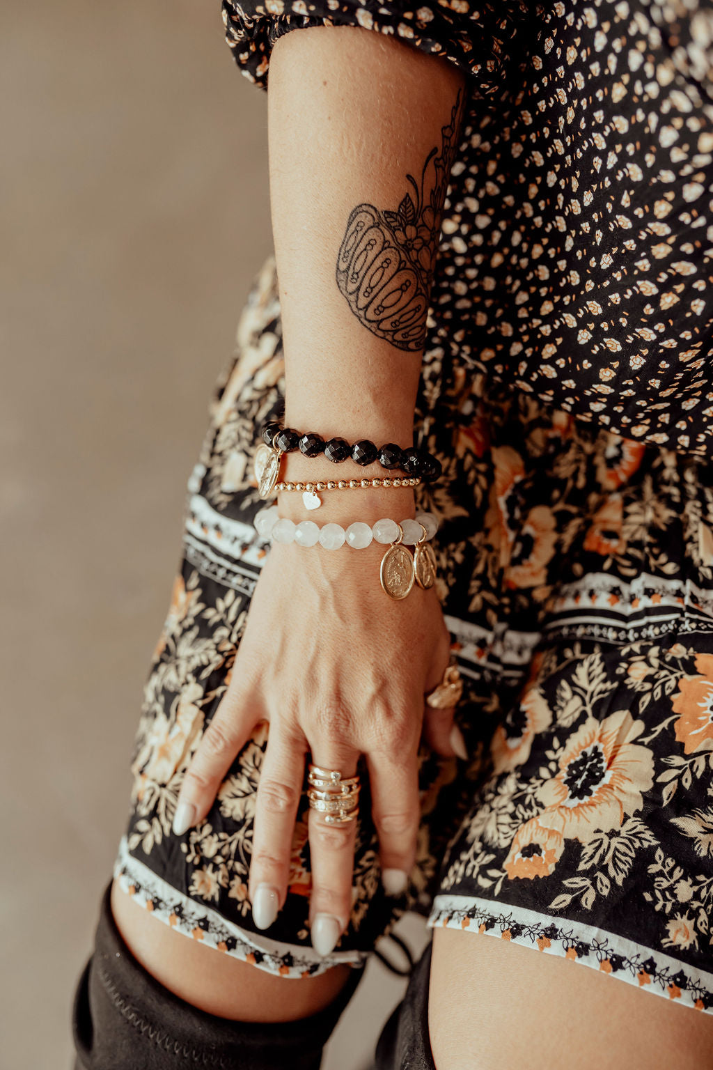 Model wearing crystal bracelet in Rose Quartz, and Onyx