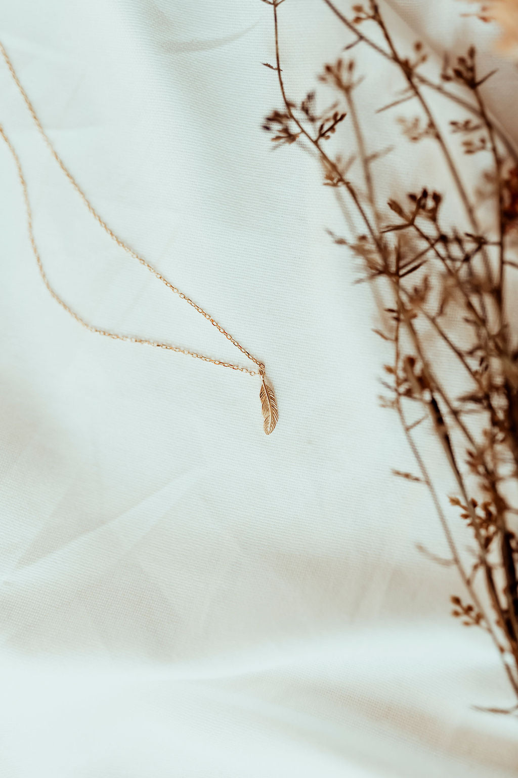 gold feather necklace zoomed out